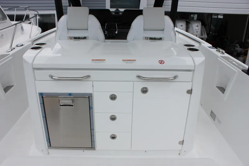 Slide: The Image of 2027 Wellcraft 28 T-Top boat interior with seating and storage compartments. - 18