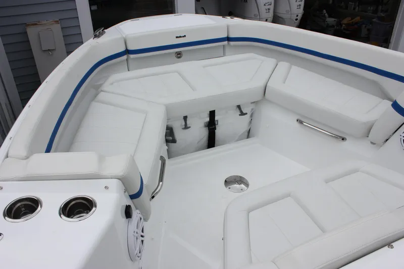 Slide: The Image of 2027 Wellcraft 28 T-Top boat interior with white seating and blue accents. - 39