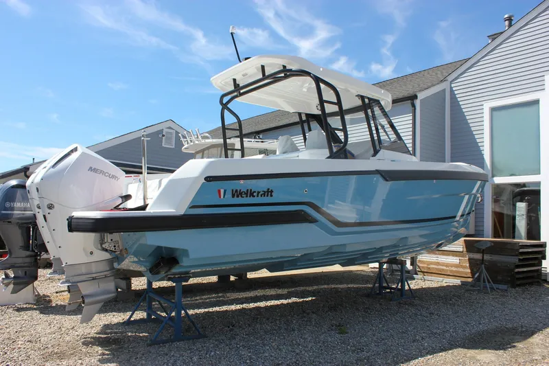 The Image of 2027 Wellcraft 28 T-Top boat with Mercury engines on display outdoors. - 0