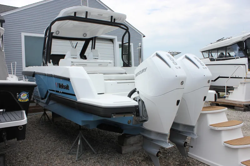 Slide: The Image of 2027 Wellcraft 28 T-Top boat with dual Mercury engines, displayed outdoors. - 8
