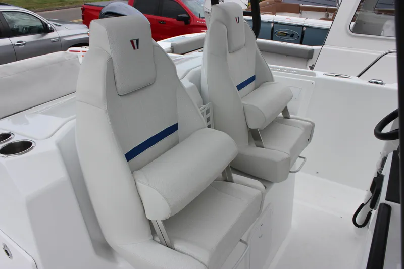 Slide: The Image of 2027 Wellcraft 28 T-Top boat interior with dual cushioned seats and cup holders. - 32