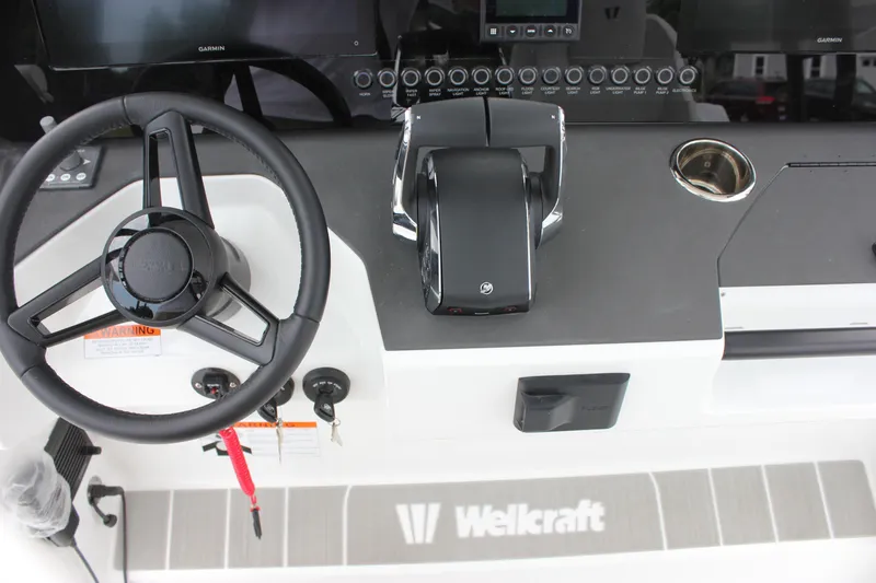 Slide: The Image of Steering console of 2027 Wellcraft 28 T-Top boat with modern controls and displays. - 30