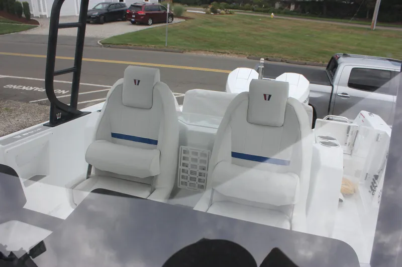 Slide: The Image of 2027 Wellcraft 28 T-Top boat interior with white seating and modern design. - 37