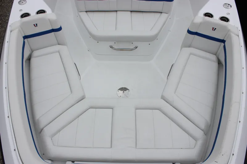 Slide: The Image of 2027 Wellcraft 28 T-Top boat interior with white cushioned seating and blue accents. - 47