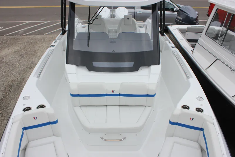 Slide: The Image of 2027 Wellcraft 28 T-Top boat with sleek white seating and blue accents. - 48