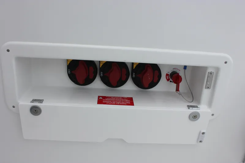 Slide: The Image of Control panel on a 2027 Wellcraft 28 T-Top boat with red switches. - 11