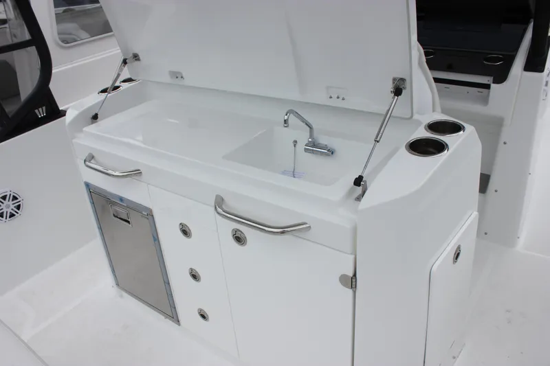 Slide: The Image of 2027 Wellcraft 28 T-Top boat interior with sink and storage area. - 21