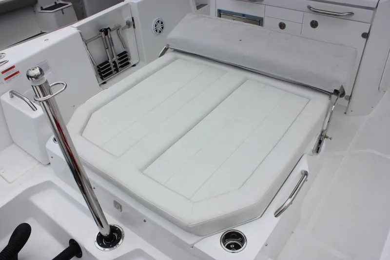 Slide: The Image of 2027 Wellcraft 28 T-Top boat interior with cushioned seating and stainless steel fixtures. - 12