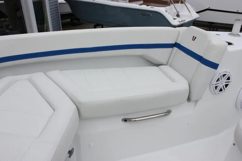 Slide: The Image of 2027 Wellcraft 28 T-Top boat interior with white seating and blue accents. - 55