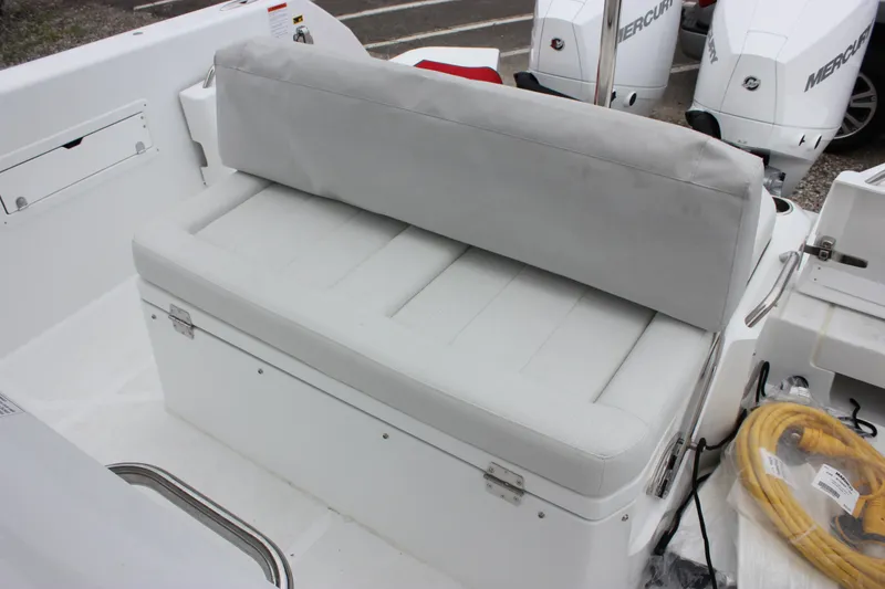 Slide: The Image of 2027 Wellcraft 28 T-Top boat seating area with cushioned bench and storage. - 17