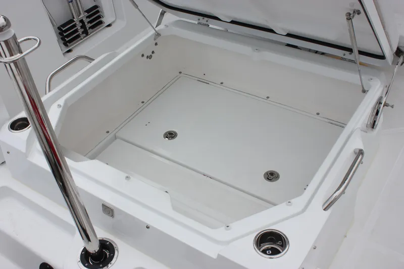 Slide: The Image of Open storage compartment on 2027 Wellcraft 28 T-Top boat, featuring stainless steel handles. - 13