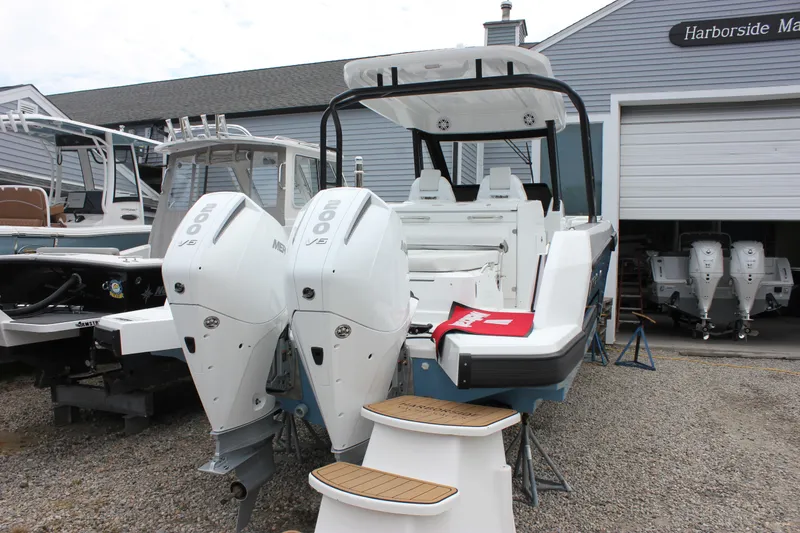 Slide: The Image of 2027 Wellcraft 28 T-Top boat with twin Mercury outboard engines at Harborside Marina. - 2