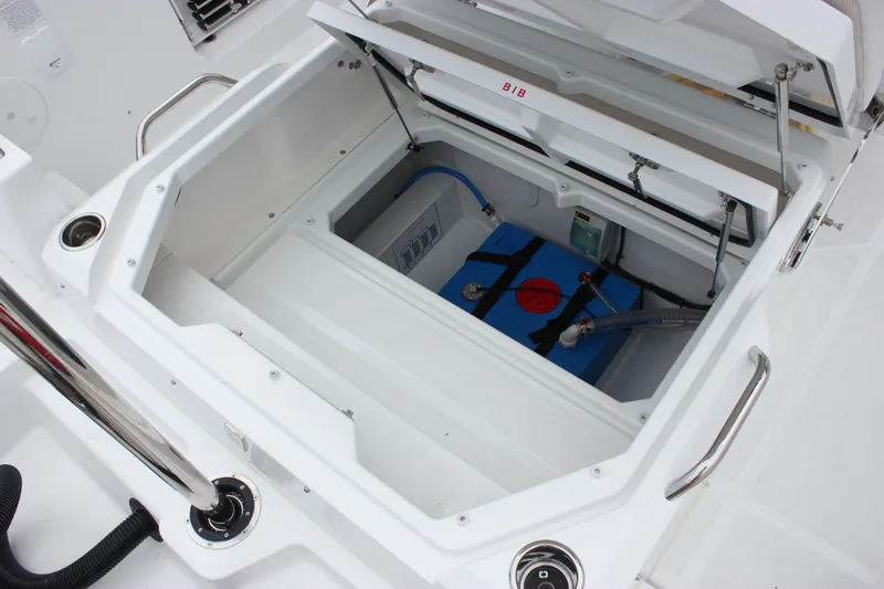 Slide: The Image of 2027 Wellcraft 28 T-Top boat storage compartment with open hatch and visible equipment. - 14