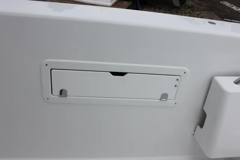 Slide: The Image of 2027 Wellcraft 28 T-Top boat storage compartment, sleek white design. - 10