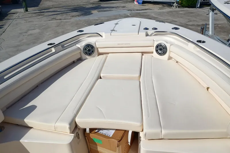 Slide: The Image of The image shows the bow area of a Grady-White Canyon 336 boat with beige cushions. - 6