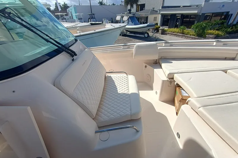 Slide: The Image of The image shows the cockpit of a Grady-White Canyon 336 boat with cushioned seating. - 13