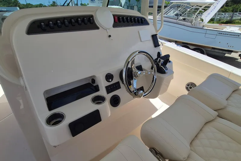 Slide: The Image of The image shows the cockpit of a Grady-White Canyon 336 boat with a modern helm station. - 11