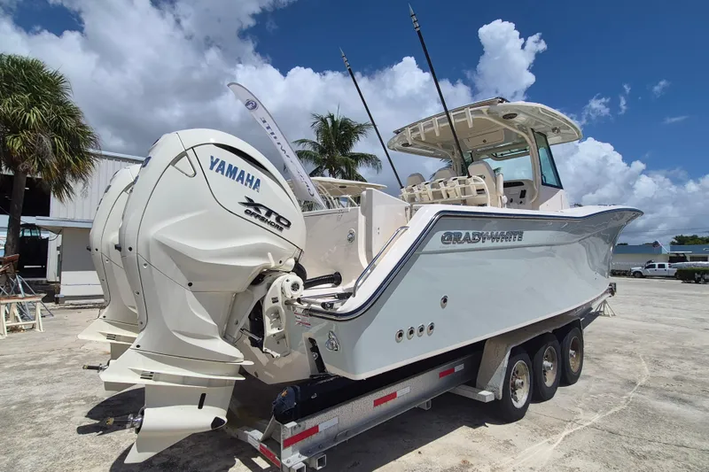 Slide: The Image of 2027 Grady-White Canyon 336 with twin Yamaha engines, on a trailer on land. - 4