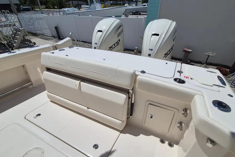 Slide: The Image of The image shows the stern of a Grady-White Canyon 336 boat with two outboard engines. - 23