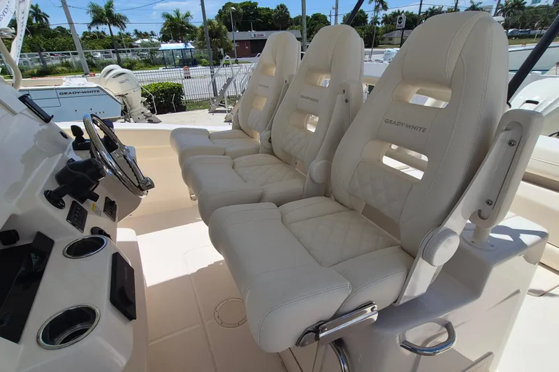 Slide: The Image of Three luxurious, padded seats on a boat with a steering wheel and dashboard. - 14