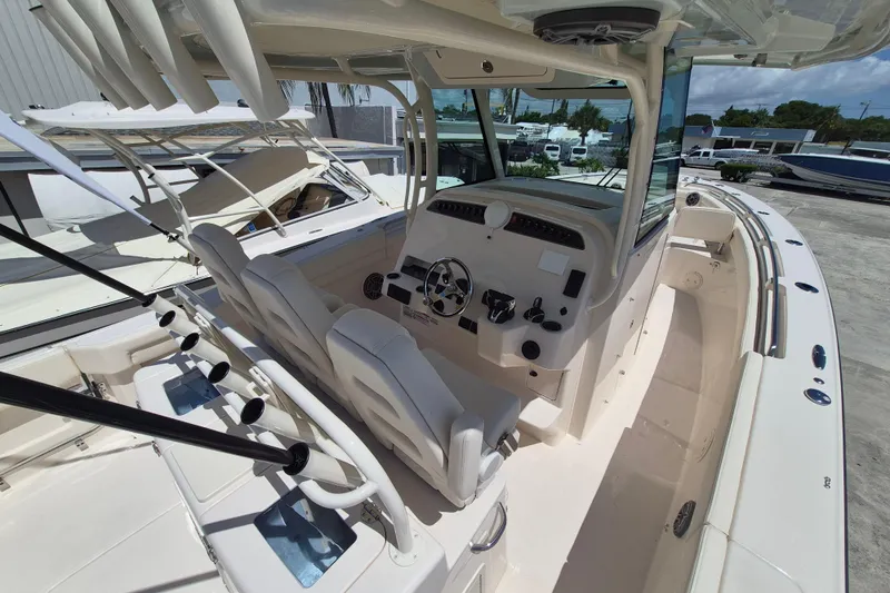 Slide: The Image of The image shows the cockpit of a Grady-White Canyon 336 boat with two seats and a helm. - 10