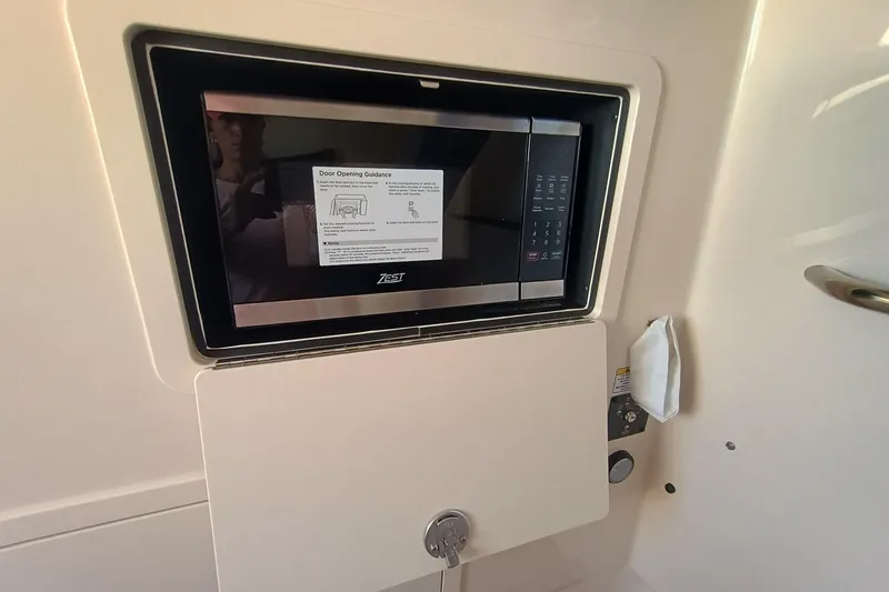 Slide: The Image of A modern microwave oven display on a boat, surrounded by white walls. - 20