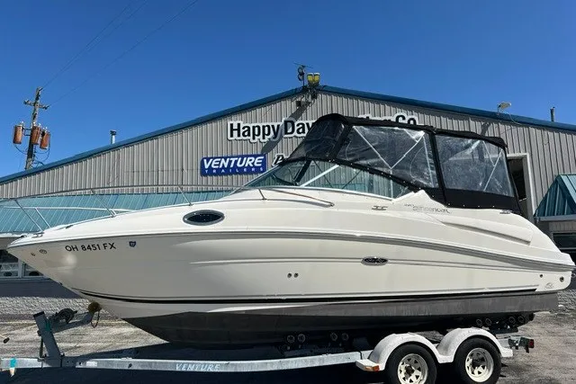 The Image of 2006 Sea Ray 240 Sundancer boat on trailer outside dealership. - 0