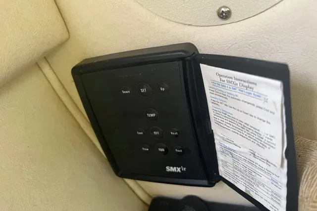 Slide: The Image of SMXir control panel on 2006 Sea Ray 240 Sundancer boat interior. - 6