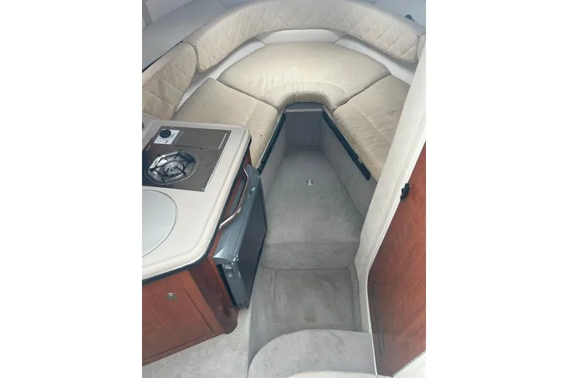 Slide: The Image of Interior of 2006 Sea Ray 240 Sundancer with kitchenette and seating area. - 3
