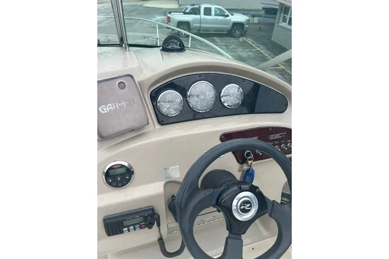 Slide: The Image of Helm of 2006 Sea Ray 240 Sundancer with steering wheel and gauges. - 8