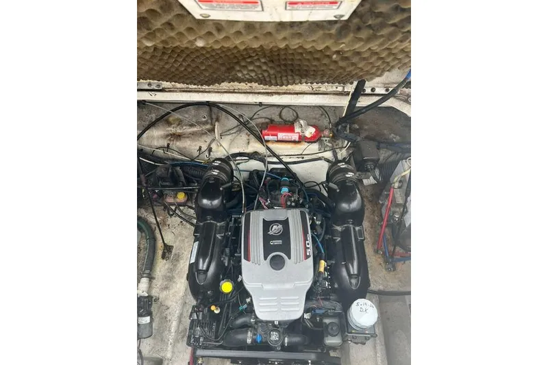 Slide: The Image of Engine compartment of a 2006 Sea Ray 240 Sundancer boat, featuring a MerCruiser engine. - 18