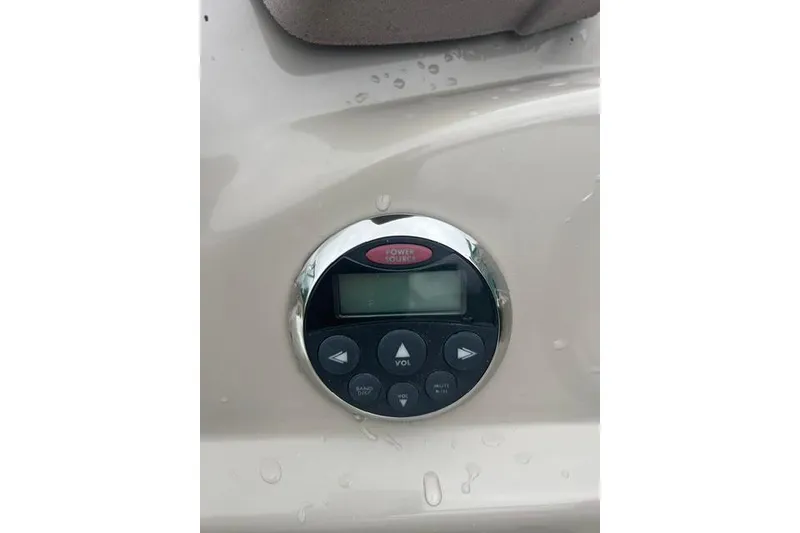 Slide: The Image of Boat audio control panel on 2006 Sea Ray 240 Sundancer, featuring volume and track buttons. - 11