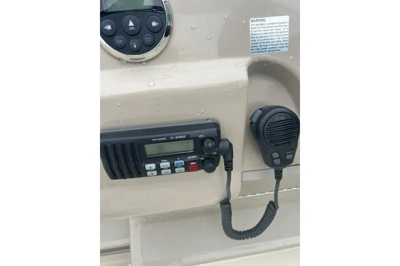 Slide: The Image of Control panel of a 2006 Sea Ray 240 Sundancer with marine radio and microphone. - 10