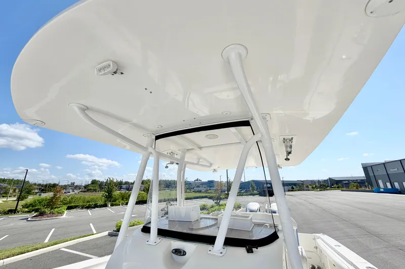 Slide: The Image of 2004 Hydra-Sports Vector 3300 CC boat with T-top, parked outdoors under blue sky. - 15