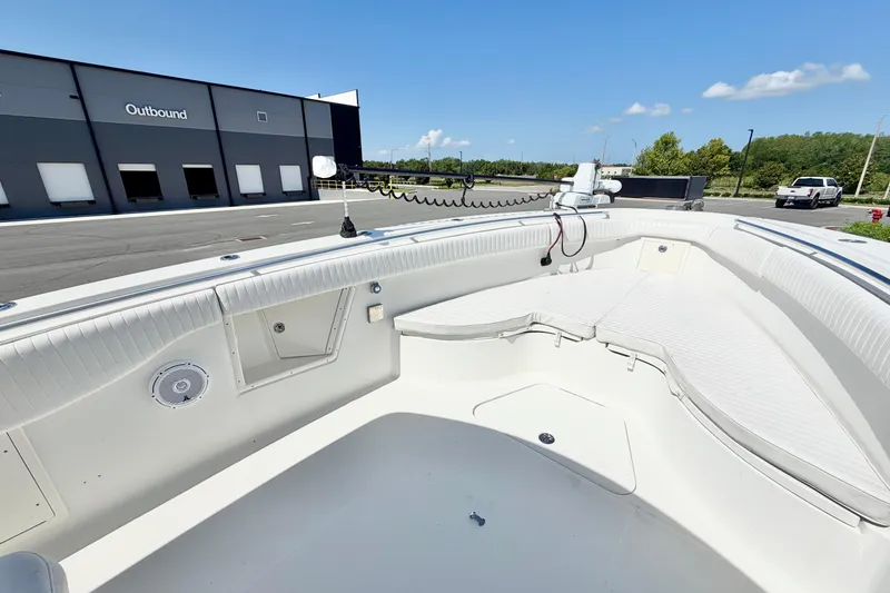 Slide: The Image of 2004 Hydra-Sports Vector 3300 CC boat interior with seating, docked near industrial building. - 19