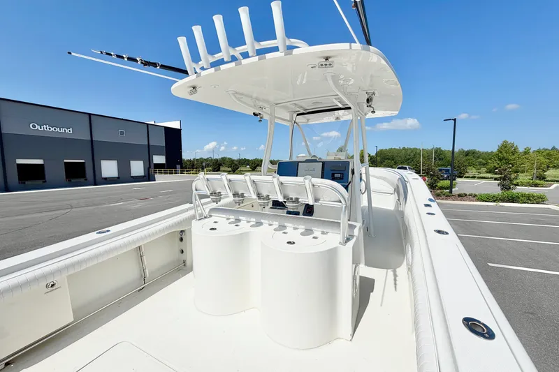 Slide: The Image of 2004 Hydra-Sports Vector 3300 CC boat with center console, docked near a modern building. - 11