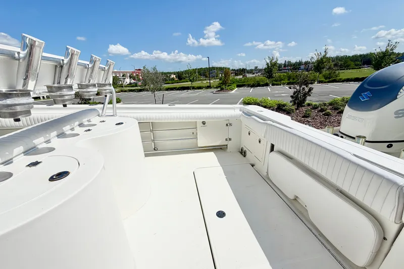 Slide: The Image of 2004 Hydra-Sports Vector 3300 CC boat interior with rod holders and Suzuki engine. - 7
