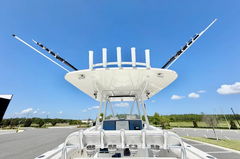 Slide: The Image of 2004 Hydra-Sports Vector 3300 CC boat with fishing rod holders, under clear blue sky. - 12