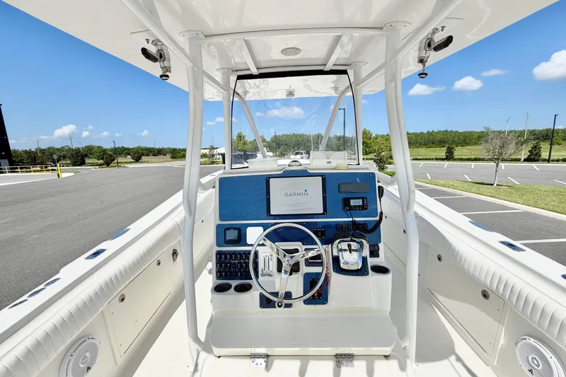 Slide: The Image of 2004 Hydra-Sports Vector 3300 CC boat cockpit with Garmin navigation system and steering wheel. - 13