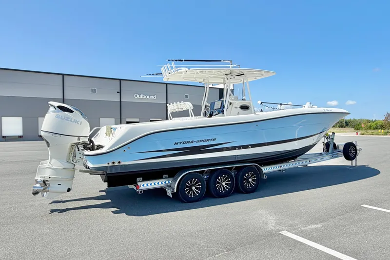 Slide: The Image of 2004 Hydra-Sports Vector 3300 CC boat on trailer, parked outdoors under clear blue sky. - 4