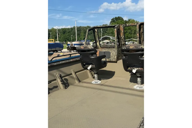 Slide: The Image of 2025 SeaArk 2272 MVT boat interior with camo seats and open deck. - 4