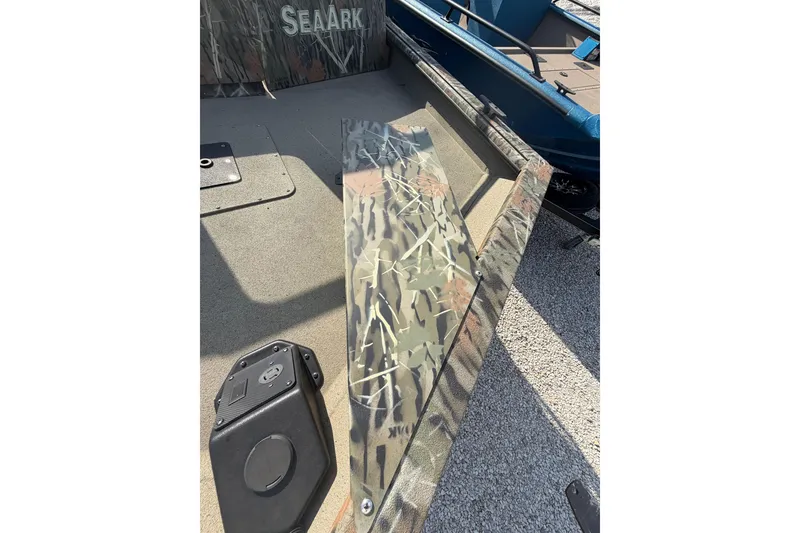 Slide: The Image of 2025 SeaArk 2272 MVT boat with camouflage design, featuring a spacious deck and storage compartment. - 3