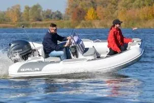 Slide: The Image of 2026 Gala Viking V330 boat with Tohatsu 30HP engine cruising on a lake. - 14