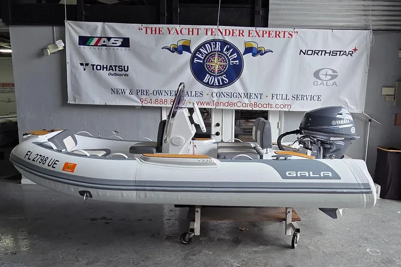 Slide: The Image of 2026 Gala Viking V330 boat with Tohatsu 30HP engine displayed indoors. - 1