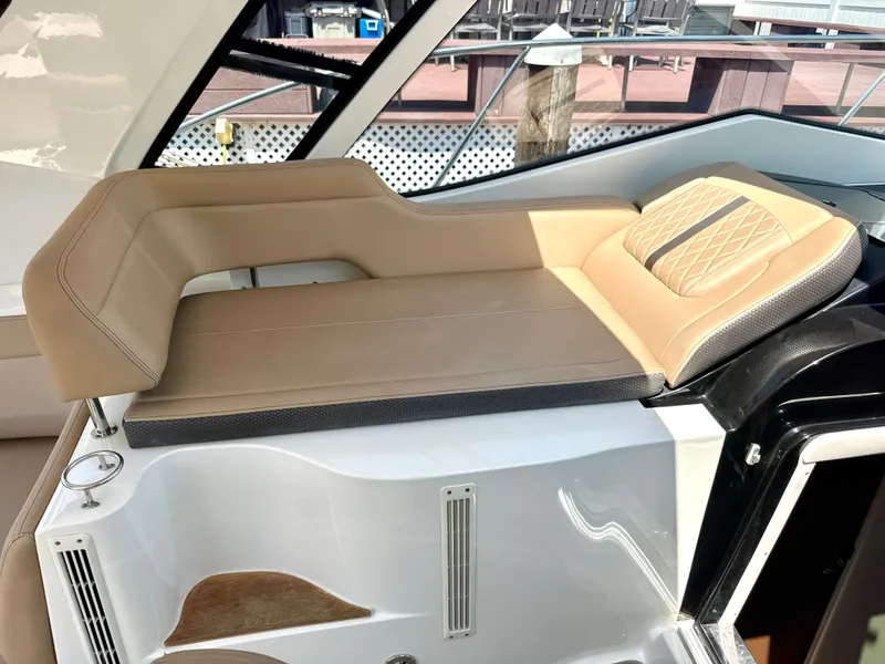 Slide: The Image of A sleek, modern sun deck on a boat with beige upholstery and stylish design. - 14