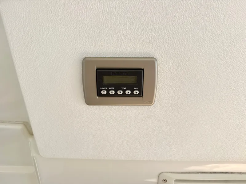 Slide: The Image of A control panel on the ceiling of a 2017 Sea Ray Sundancer 350 Coupe. - 11