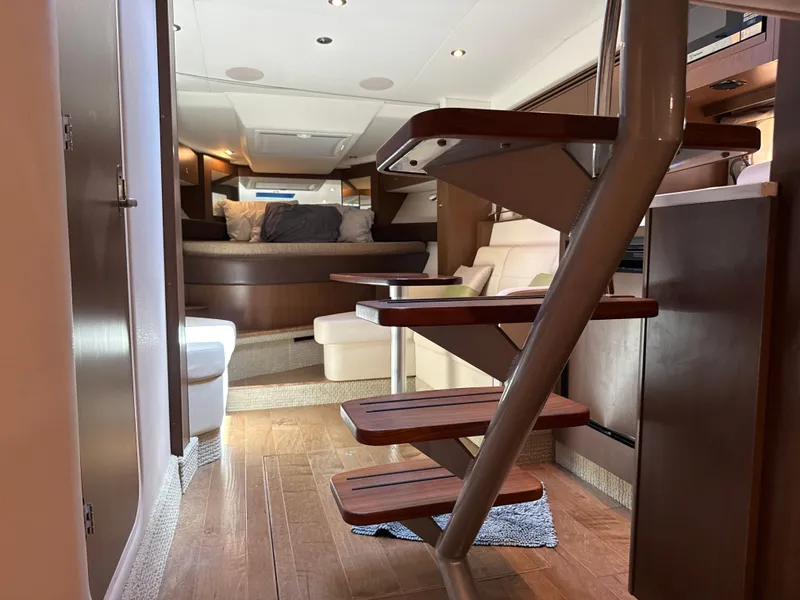 Slide: The Image of Interior of a 2017 Sea Ray Sundancer 350 Coupe with wooden stairs and cozy seating area. - 37