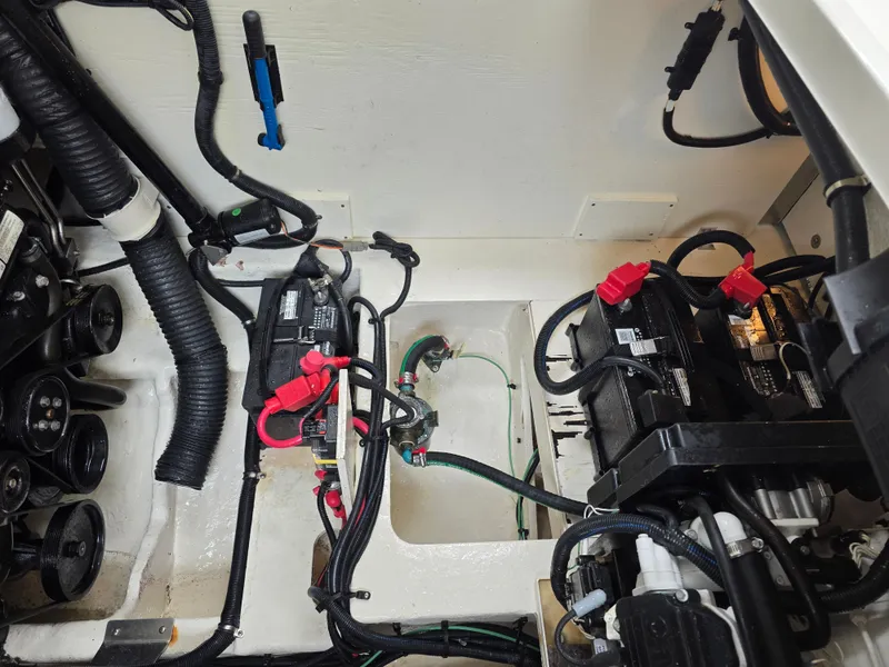 Slide: The Image of View of the engine compartment of a 2017 Sea Ray Sundancer 350 Coupe with batteries and wiring. - 43
