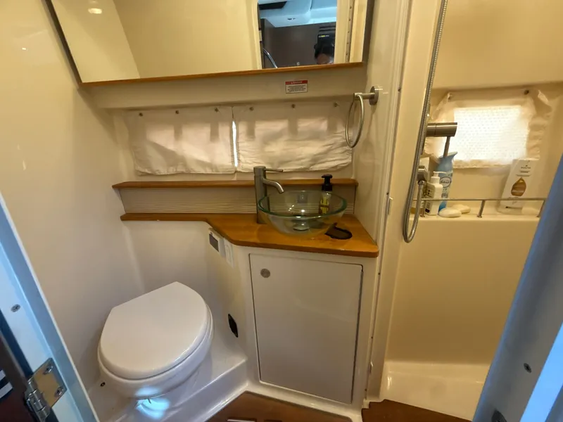 Slide: The Image of Bathroom in a 2017 Sea Ray Sundancer 350 Coupe with toilet and sink. - 32