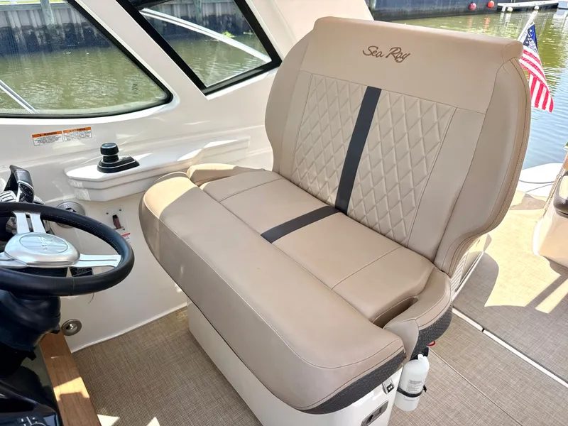 Slide: The Image of Interior of the Sea Ray Sundancer 350 Coupe with beige seating and steering wheel. - 15